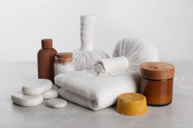 Photo of Spa composition with care products on light grey marble table