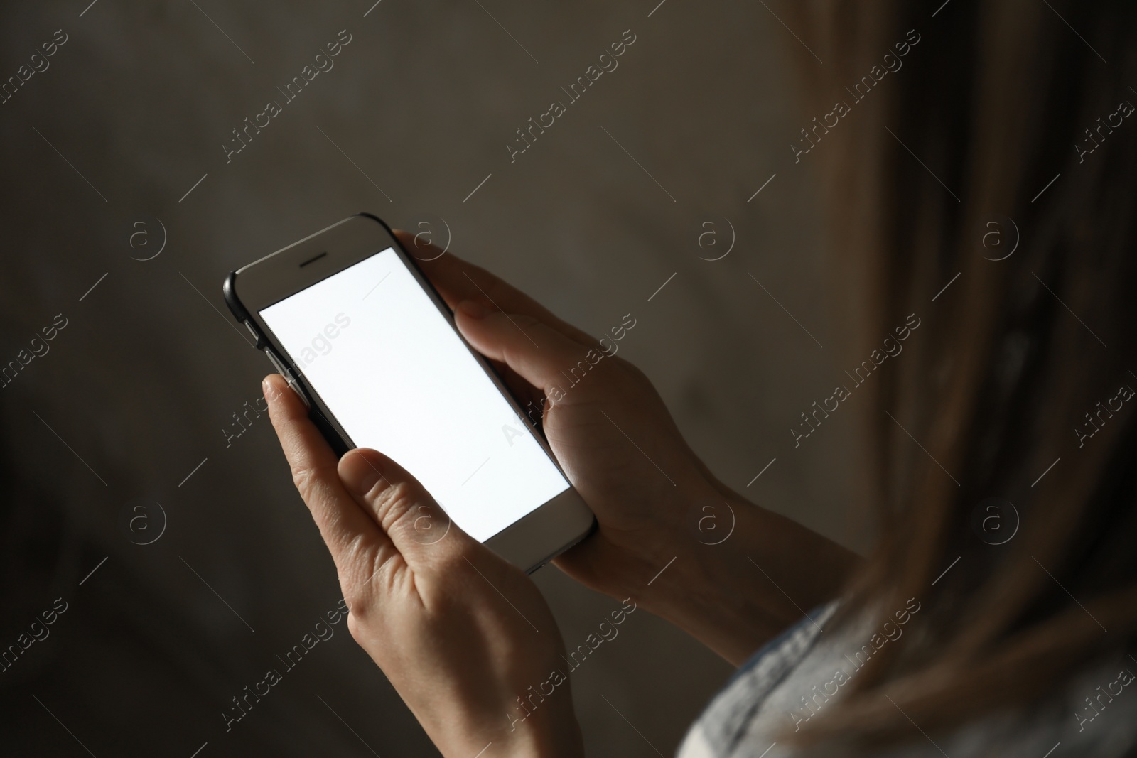 Photo of Woman using smartphone in dark room, closeup with space for text. Loneliness concept