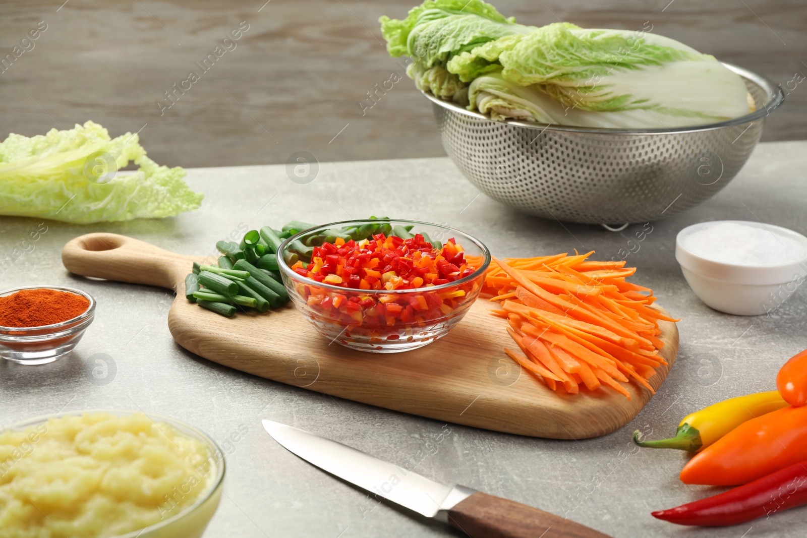 Photo of Fresh Chinese cabbages and other ingredients for kimchi on light grey table