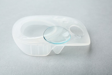 Package with contact lens on light background