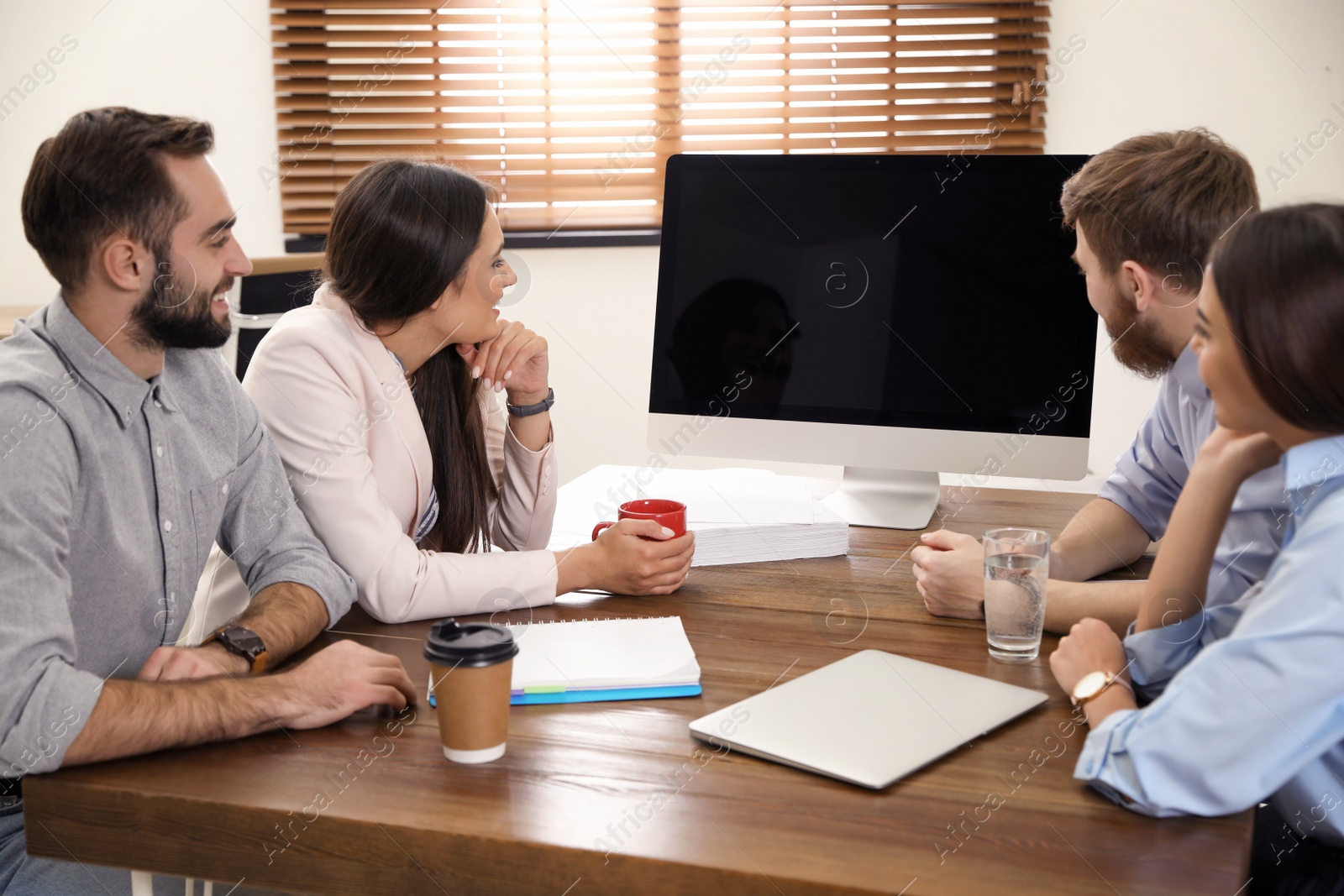 Photo of Group of colleagues using video chat on computer in office. Space for text