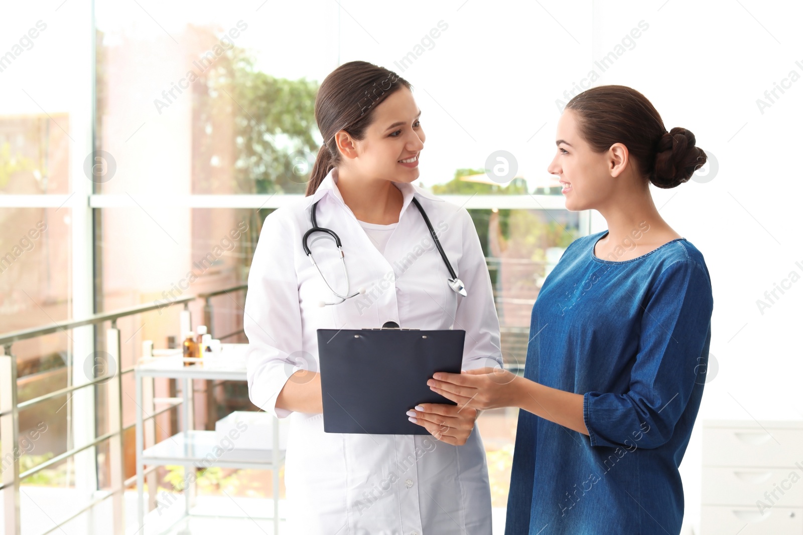 Photo of Young doctor consulting patient in modern hospital