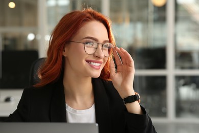 Portrait of beautiful happy woman against blurred background. Work in office