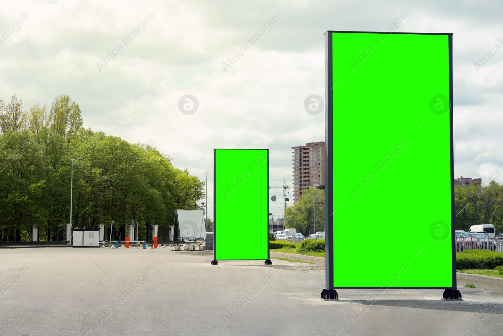 Image of Chroma key compositing. Empty billboards with green screen on city street. Mockup for design