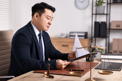 Notary working at wooden table in office