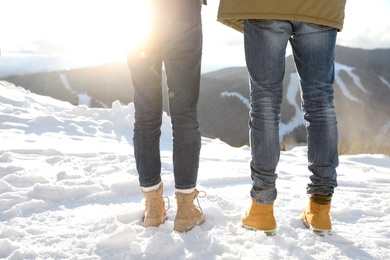 Photo of Couple walking on sunny winter day after snow storm