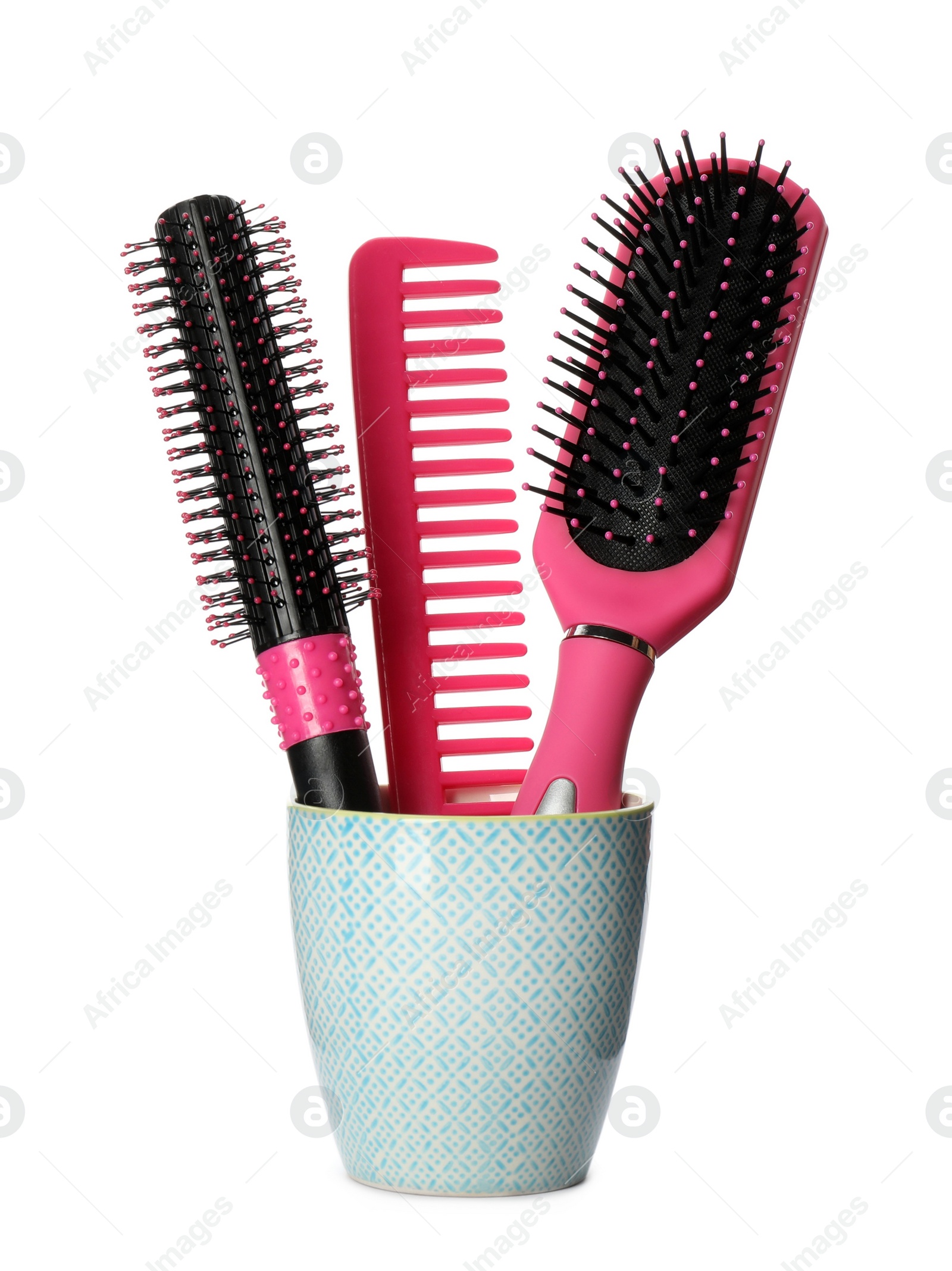 Photo of Hairbrushes and comb in holder on white background