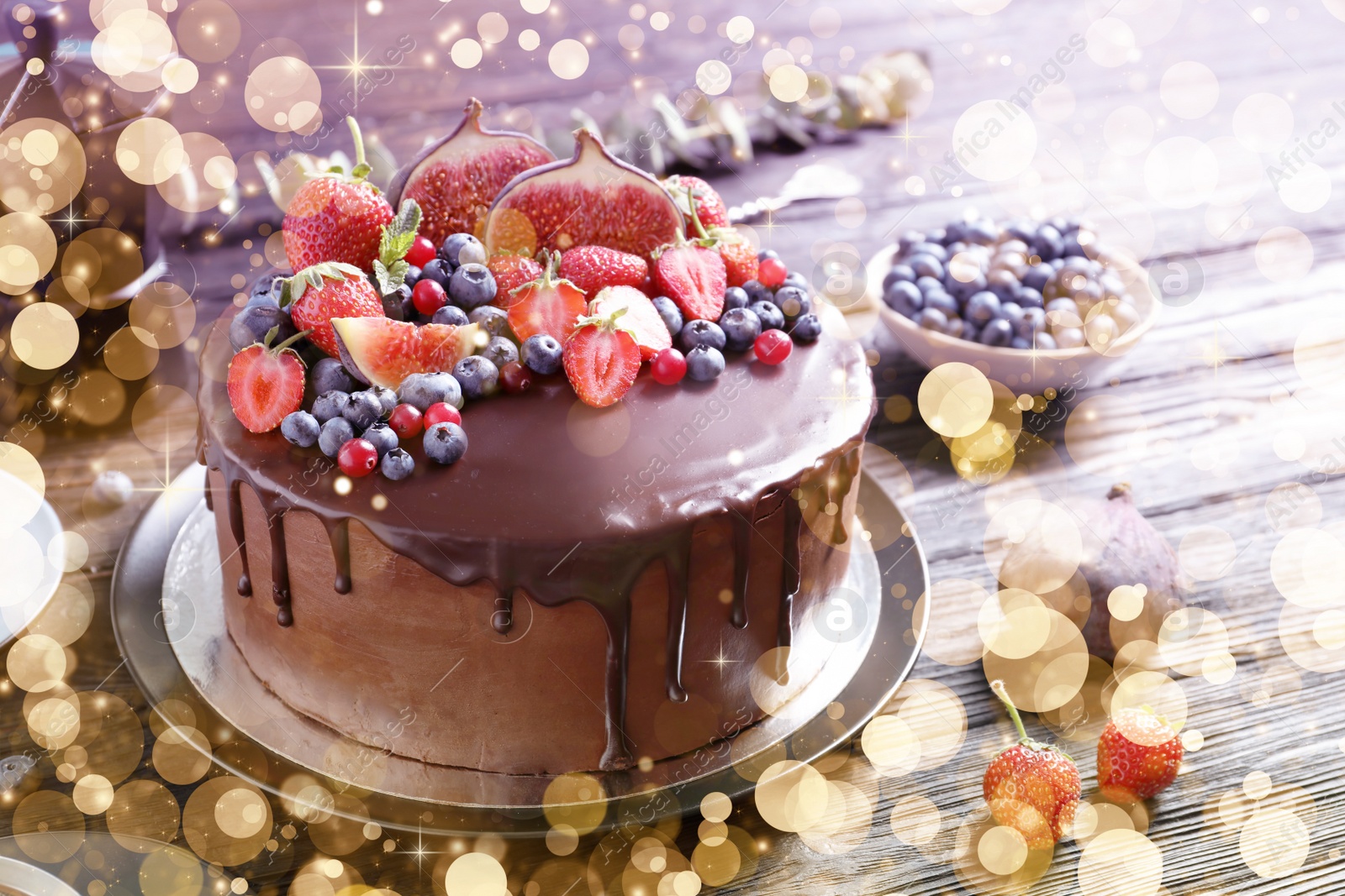 Image of Yummy chocolate cake with berries on wooden table. Tasty dessert for Christmas dinner