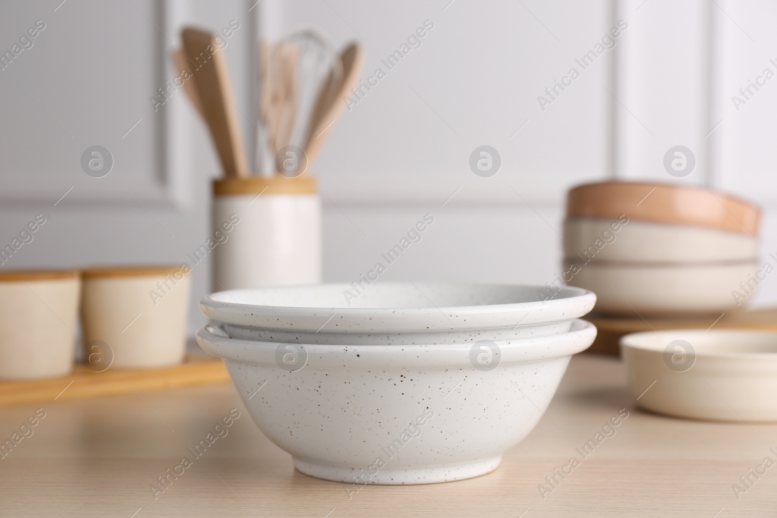 Photo of Two ceramic bowls on wooden table indoors