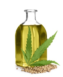 Photo of Bottle with hemp oil, leaf and seeds on white background