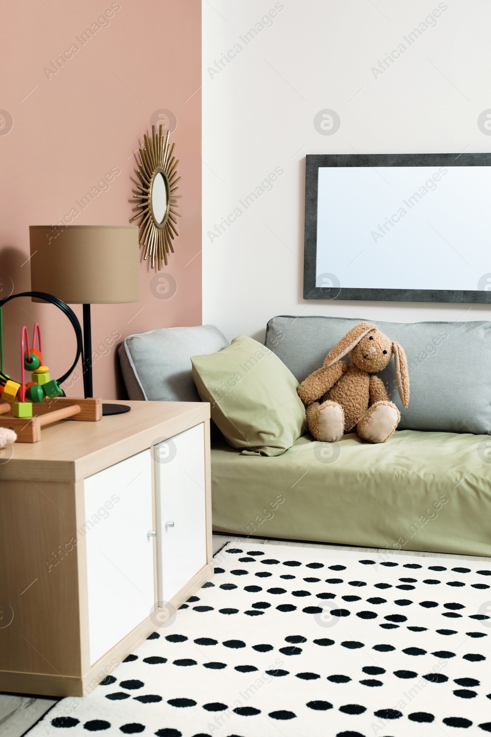 Photo of Montessori bedroom interior with floor bed and toys