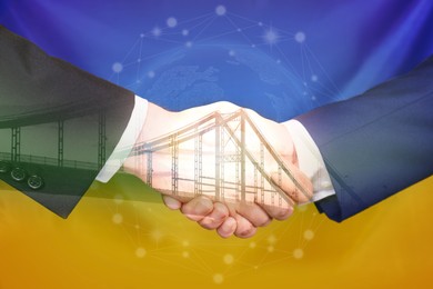 Image of Double exposure of bridge and men shaking hands against Ukrainian national flag, closeup. International relationships