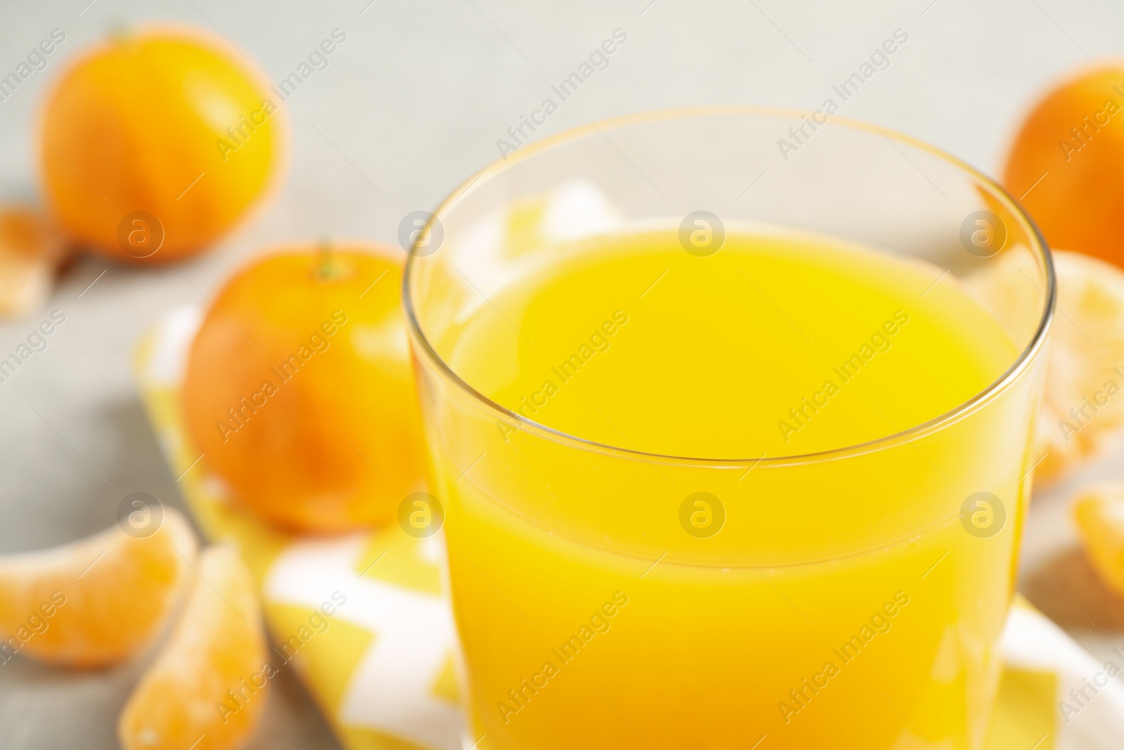 Photo of Glass of fresh tangerine juice, closeup view