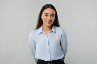 Photo of Portrait of beautiful young woman on light grey background