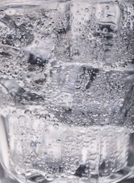 Closeup view of soda water with ice in glass