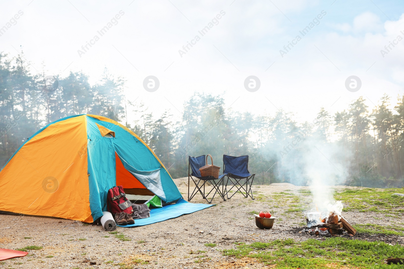 Photo of Camping tent and accessories in wilderness on summer day