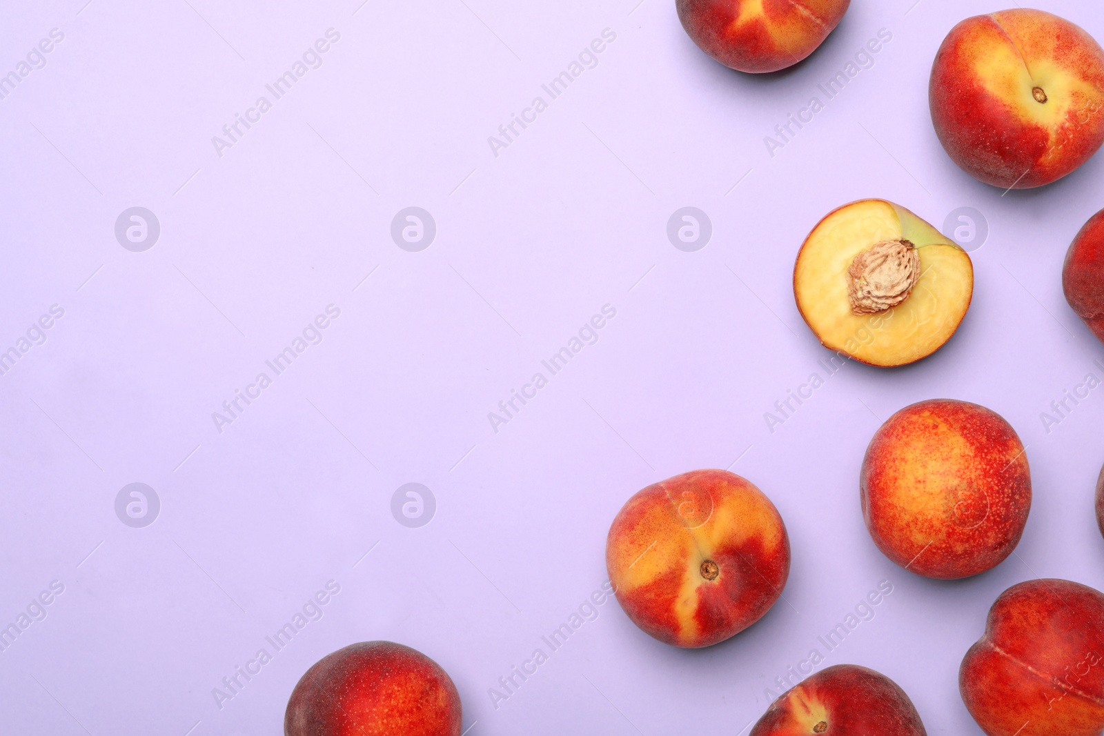 Photo of Sweet juicy peaches on lilac background, top view. Space for text