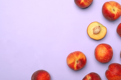 Photo of Sweet juicy peaches on lilac background, top view. Space for text