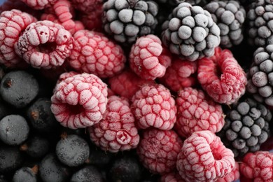 Photo of Mix of different frozen berries as background, top view