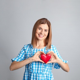 Photo of Portrait of woman with decorative heart on color background