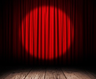 Empty wooden stage and closed red curtains