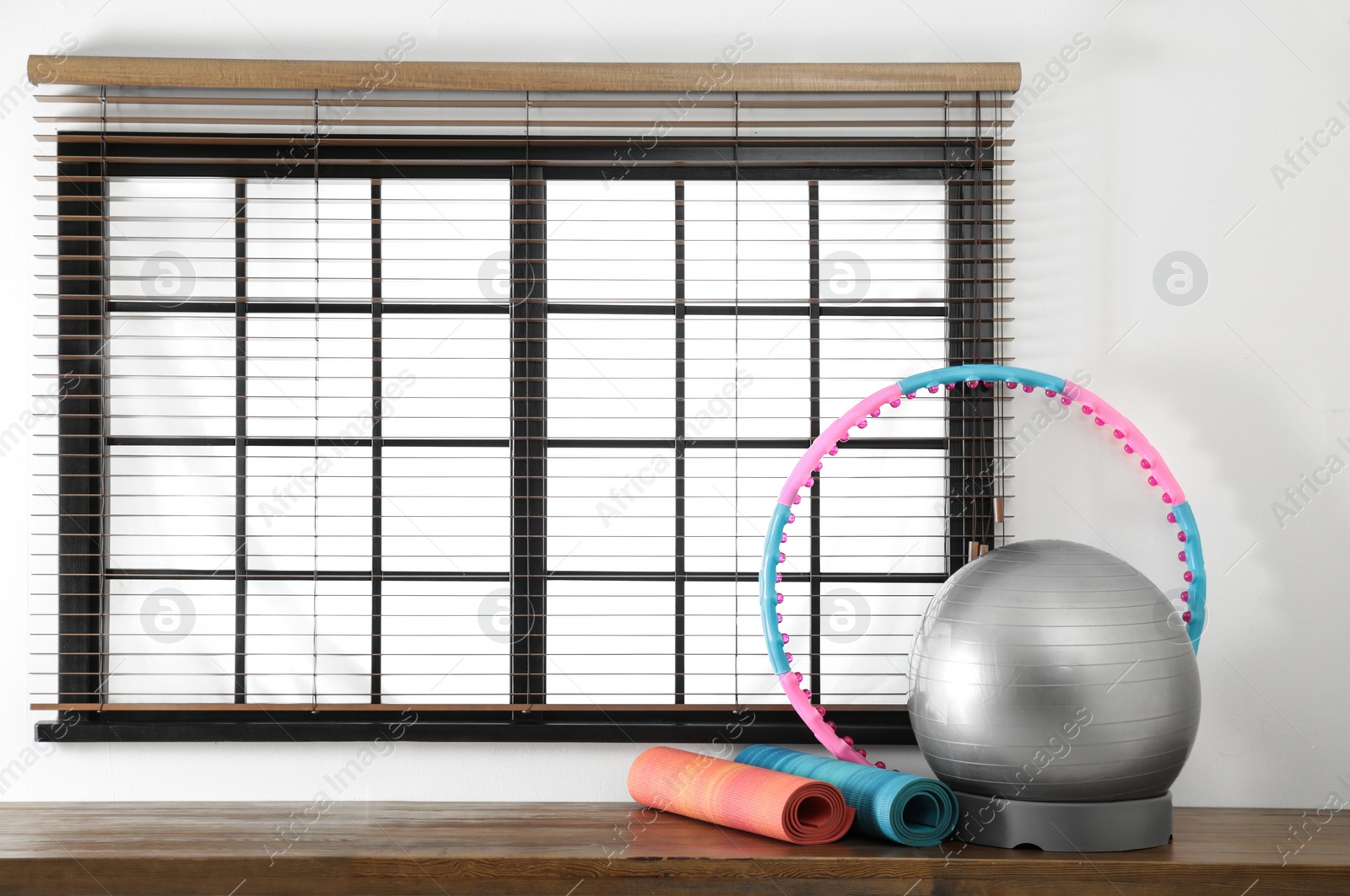 Photo of Set of fitness inventory near window, space for text. Rehabilitation medicine