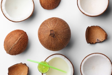 Photo of Composition with coconuts and drink on white background, top view