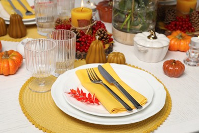 Autumn table setting with pumpkin shaped decor elements