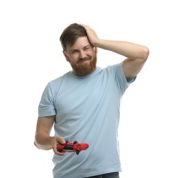 Confused man with game controller on white background