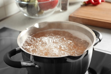 Cooking pasta in pot on electric stove