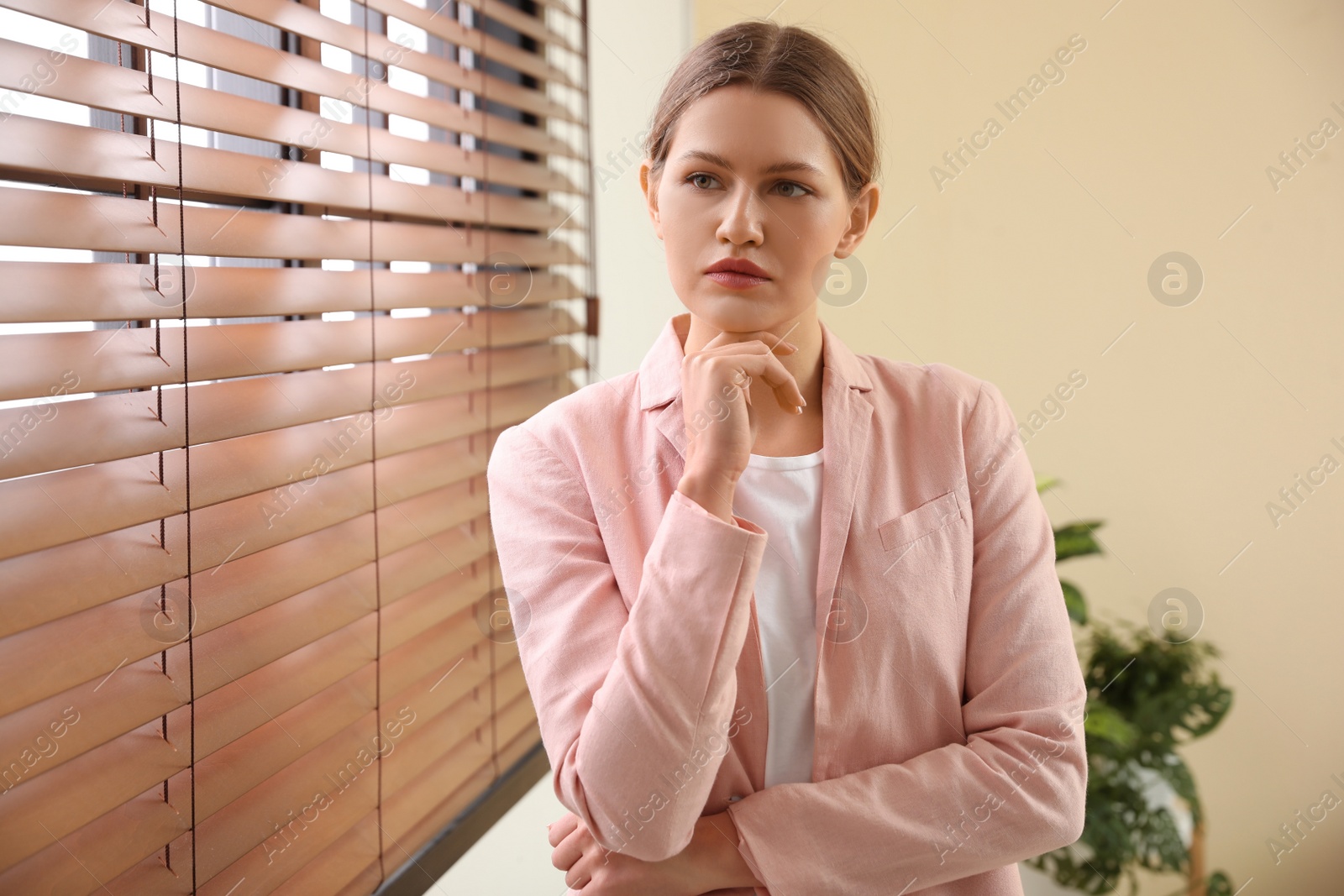 Photo of Professional psychotherapist near window in modern office