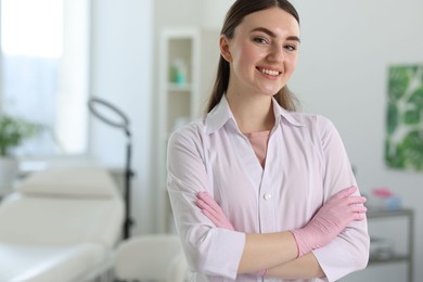 Photo of Cosmetologist in medical uniform in clinic, space for text