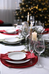 Photo of Christmas table setting with festive decor and dishware, space for text
