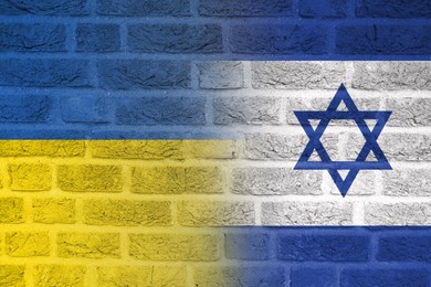 Image of Flags of Ukraine and Israel on brick wall. International diplomatic relationships