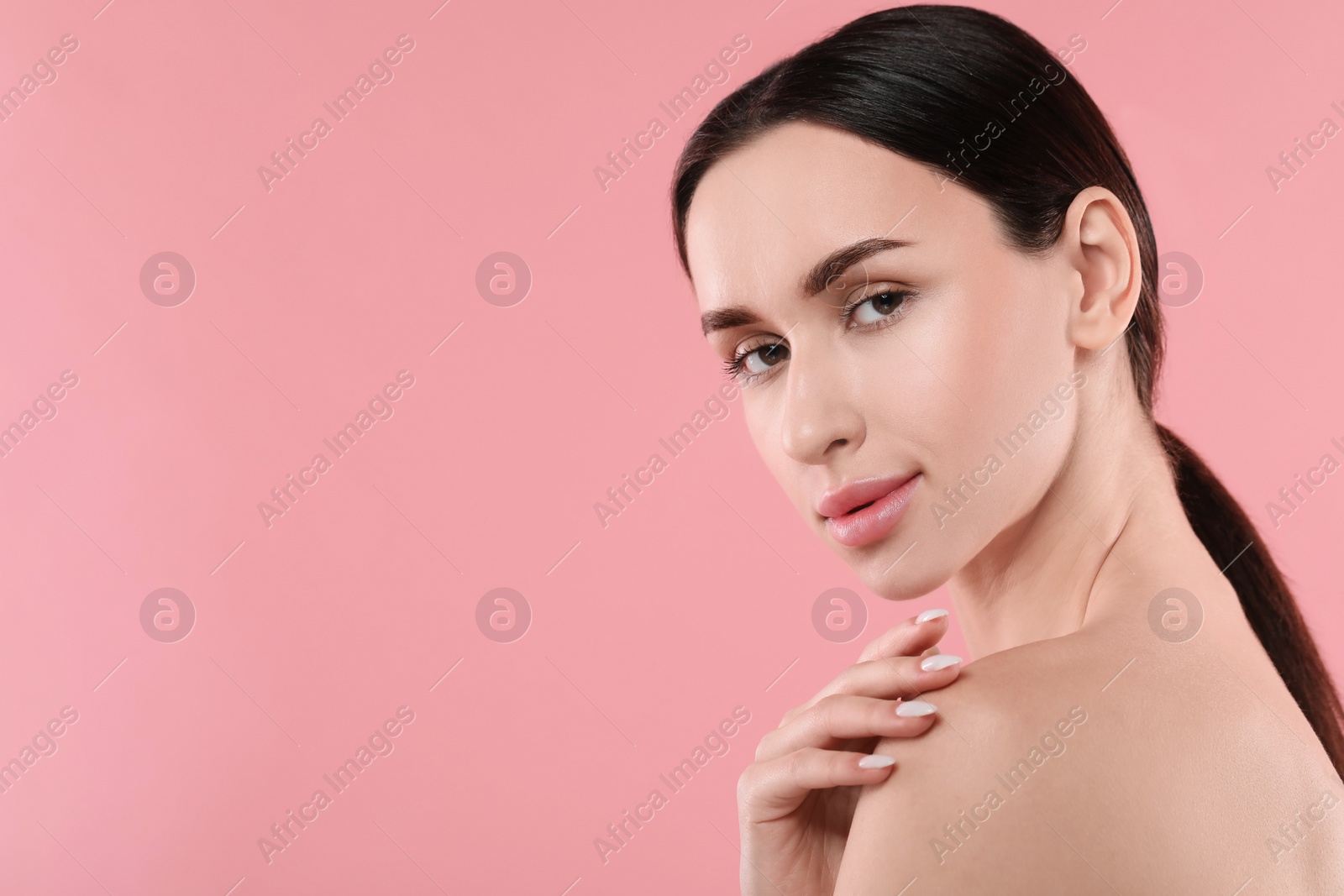 Photo of Portrait of beautiful young woman on pink background. Space for text