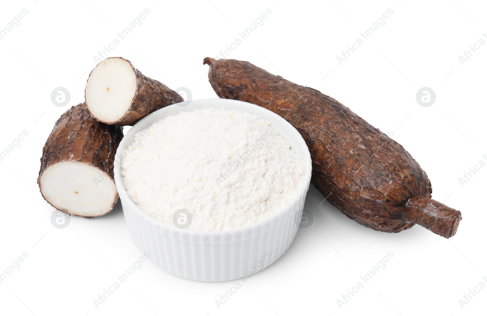 Photo of Bowl with cassava flour and roots isolated on white