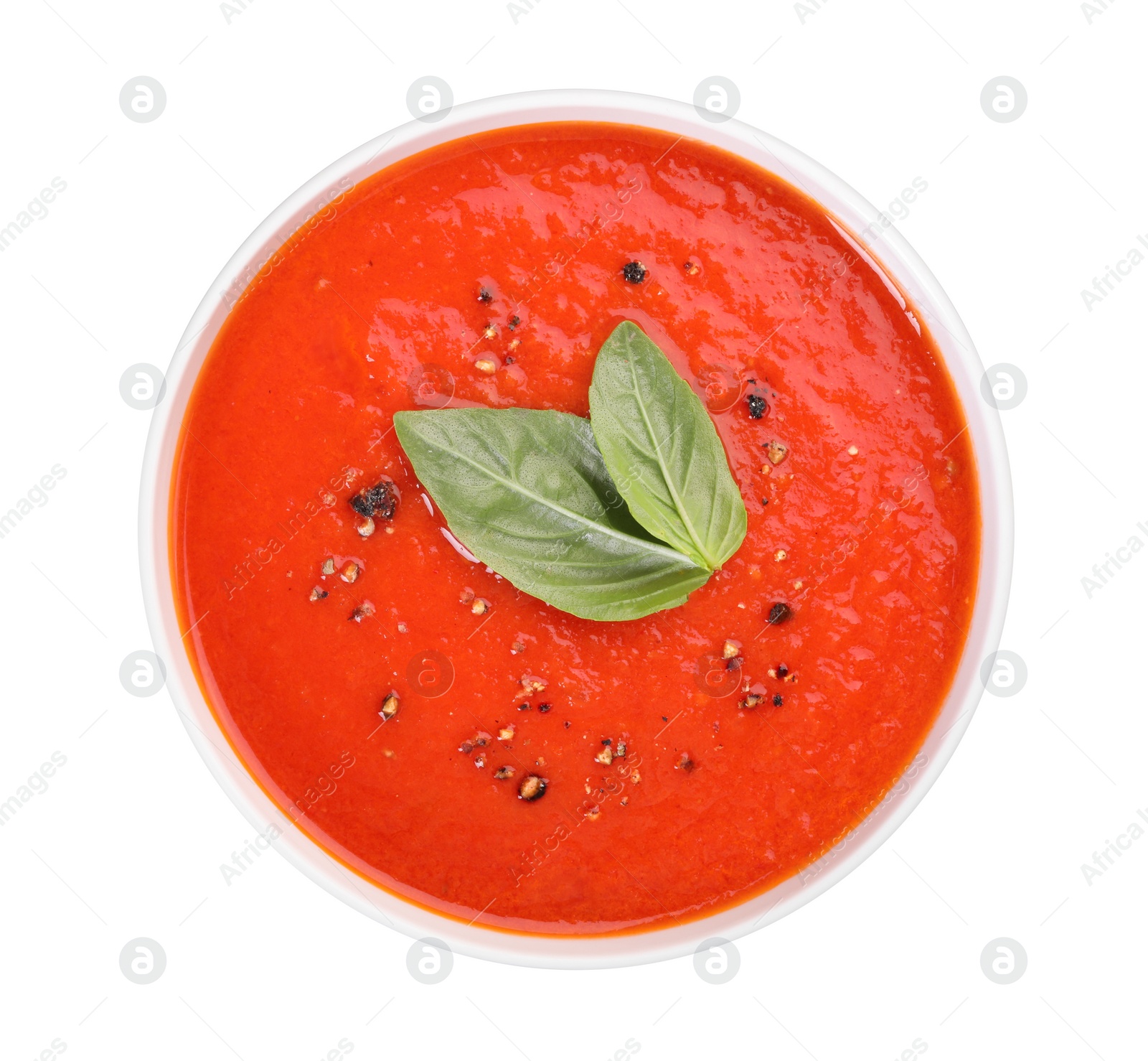 Photo of Delicious tomato cream soup in bowl isolated on white, top view