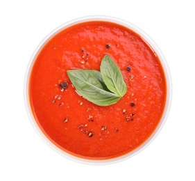 Photo of Delicious tomato cream soup in bowl isolated on white, top view