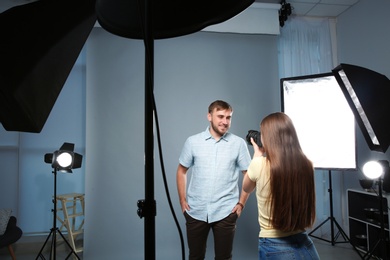 Handsome model posing for professional photographer in photo studio