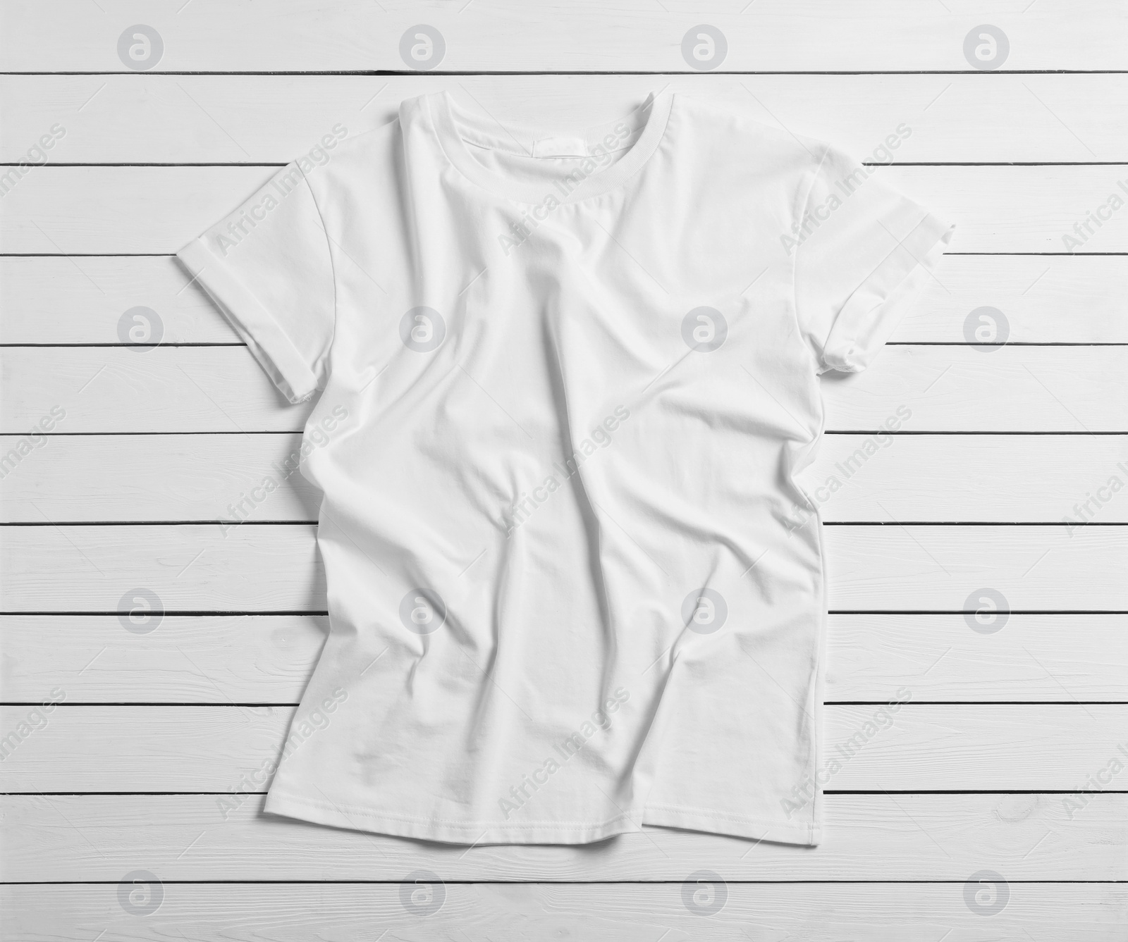 Photo of Stylish t-shirt on white wooden background, top view