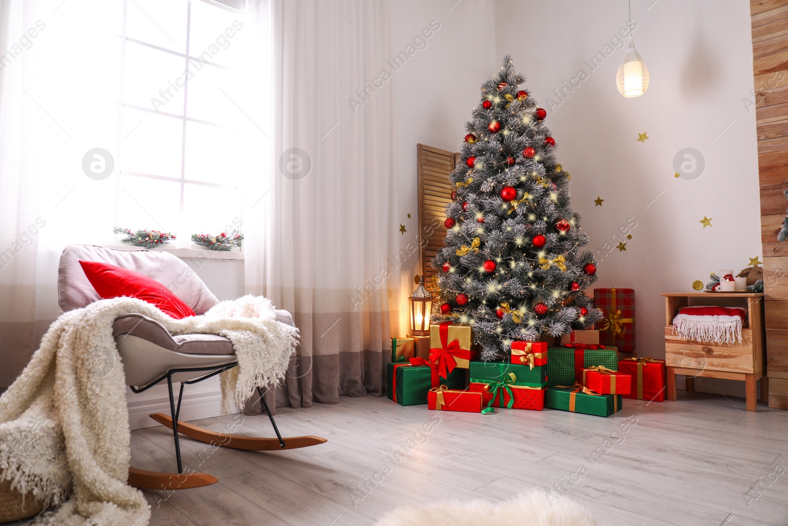 Photo of Stylish room interior with beautiful Christmas tree and gift boxes