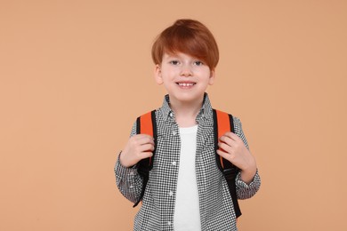 Photo of Portraithappy schoolboy on beige background