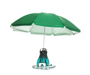 Photo of Open green beach umbrella, blanket and diving equipment on white background