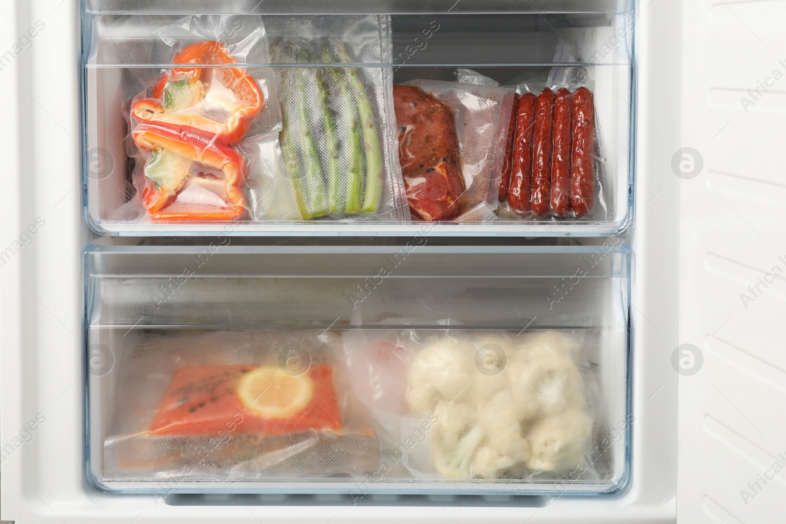 Photo of Vacuum bags with different products in fridge. Food storage