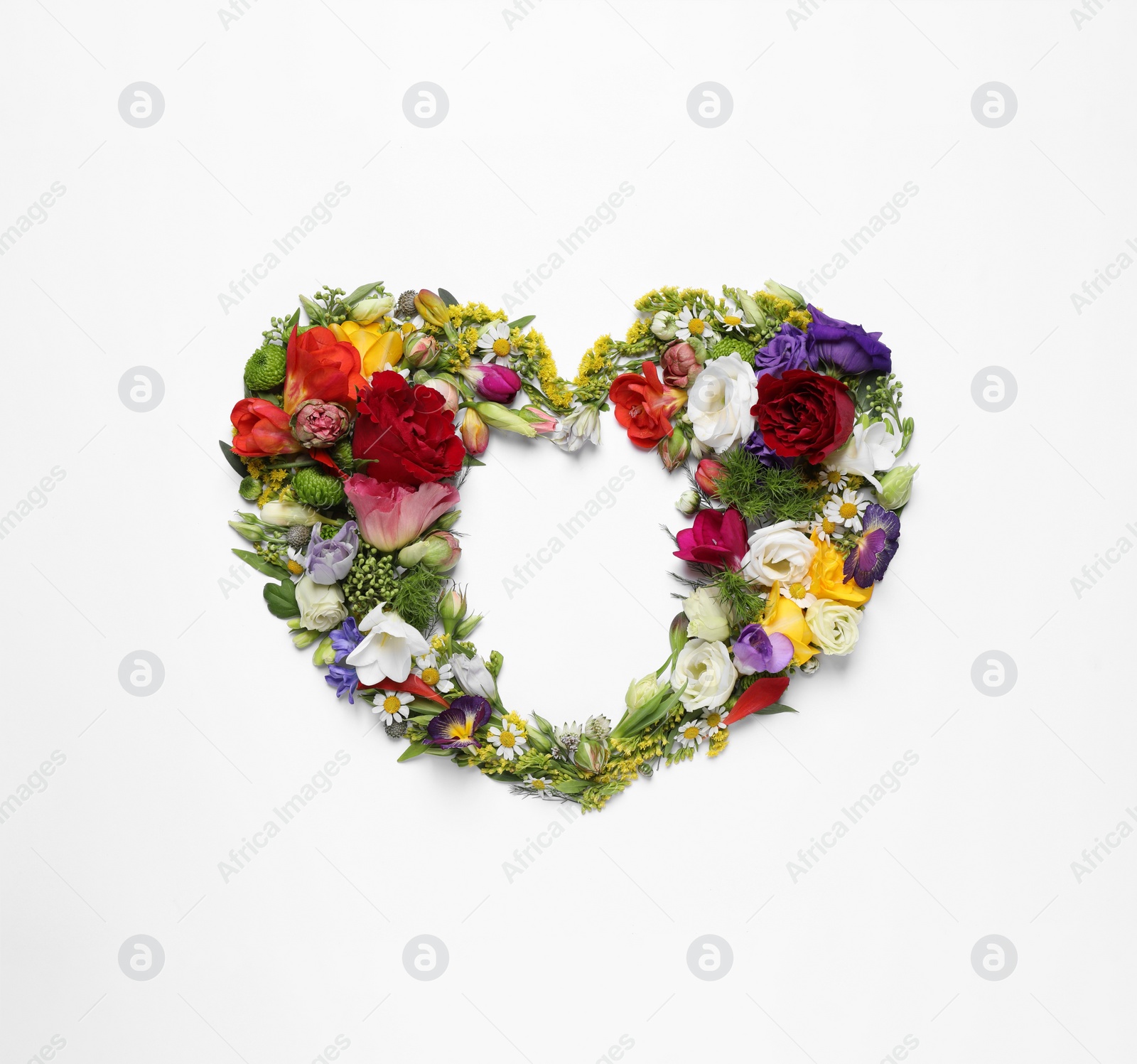 Photo of Beautiful heart made of different flowers on white background, top view