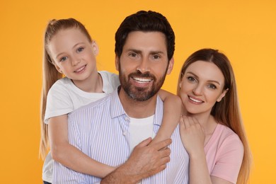 Photo of Portrait of happy family on orange background