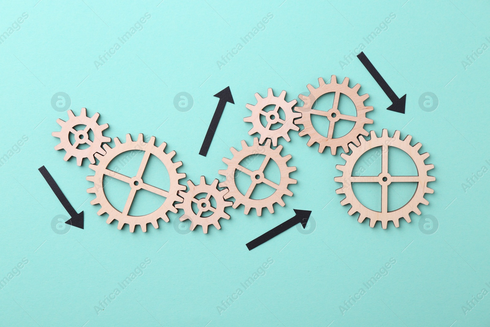 Photo of Business process organization and optimization. Scheme with wooden figures and arrows on light blue background, top view