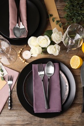 Photo of Elegant festive table setting on wooden background, flat lay