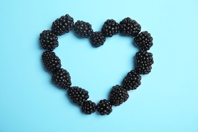 Photo of Flat lay composition with ripe blackberries on color background