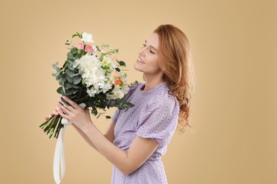 Photo of Beautiful woman with bouquet of flowers on beige background